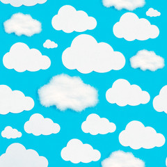 A pattern of cut-out white clouds on a blue background.