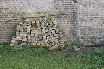 many bricks lie near the old wall in the old European city