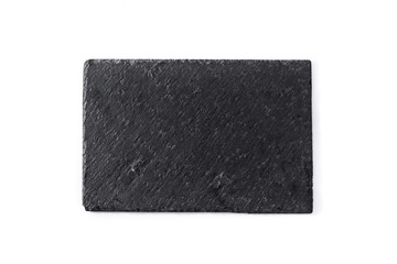 Empty black slate plate isolated on white background. Top view