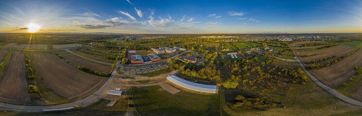 360&deg; Panoramic drone picture of the city Moerfelden-Walldorf with the skyline of Frankfurt in the background at evening