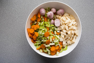 white bowl with colorful freshly chopped carrots, parsley, celery and shallots