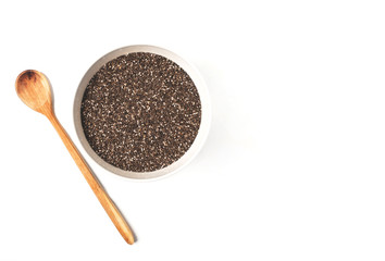 Chia seeds in bowl and wooden spoon on white background. Top view or flat-lay. Healthy superfood. Copy space for text.