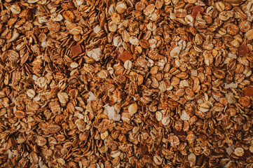 Homemade Granola Cereal with oats, nuts and dried fruits. Texture oatmeal granola or muesli as background. Top view or flat-lay. Copy space for text.