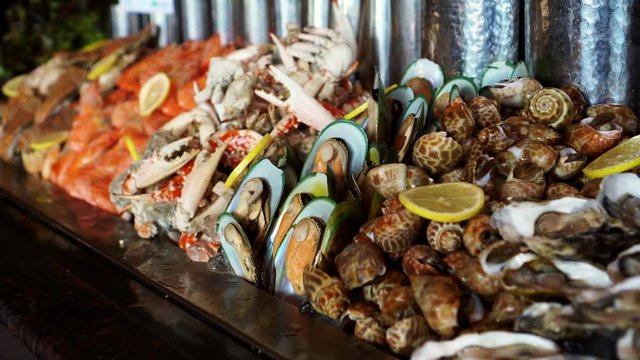Row of cold seafood buffet in hotel mussels clams crabs prawns