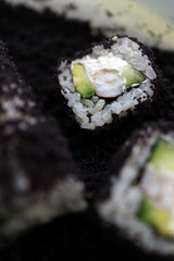 Sushi roll with black caviar close-up