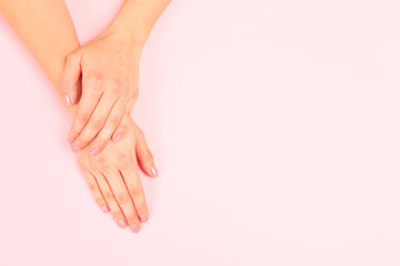 female  manicure. Beautiful young woman's hands on pastel pink  background - Image