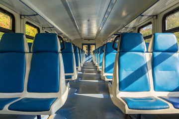 Blue seats in an electric train carriage without passengers