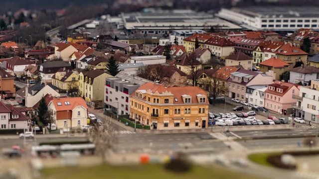 Aerial view of the Divoka Sarka tram stop and Liboc neighborhood in  Prague, Chehia. Usual traffic on the Evropska avenue, cars, busses and trams. Hvezda park is seen in a distance.