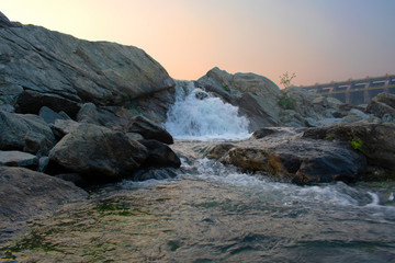 Fototapeta na wymiar closeup image of water flowing between the rocks