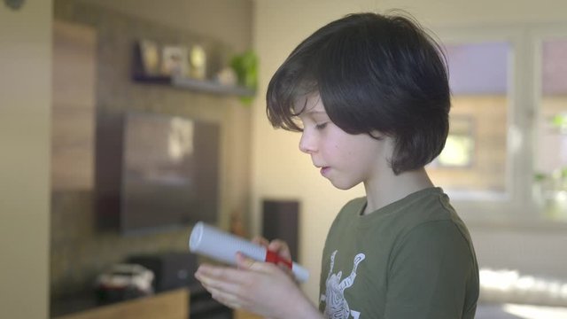 Young boy using Spirometer, Measuring Lung Capacity and Force Expiratory Volume.
Close-up of boy using spirometer at home.