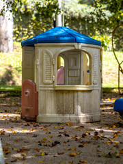 Toy house for children, abandoned in the dry leaf garden, Petropolis, Rio de Janeiro, Brazil