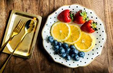 Girly and feminine presentation of plate of colorful fruits