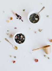 varieties of dry tea, herbal, green, black tea and fruit tea on antique silver teaspoons