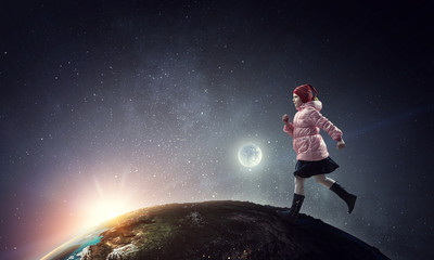Obraz na płótnie Canvas A little girl walks on a beautiful full moon night.