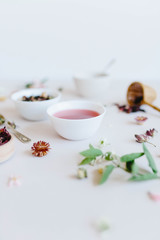 varieties of dry tea, herbal, green, black tea and fruit tea on antique silver teaspoons