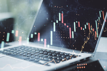 Multi exposure of abstract creative financial graph with world map on modern laptop background, forex and investment concept