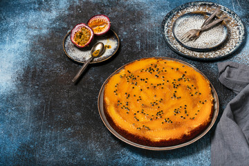 Homemade whole mango upside down cake with passion fruit on a dark rustic background. Sweet food concept. Selective focus. Copy space.