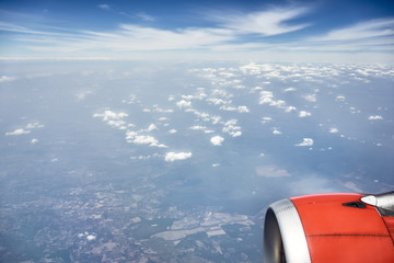 Beautiful view through the window of the plane, view of the engine, sky and clouds