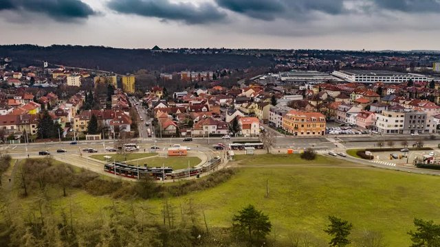 Aerial view of the tram stop near the Divoka Sarka park and Liboc residential district in Prague. Usual traffic on the Evropska avenue, cars, busses and trams. People walking on the sidewalks.