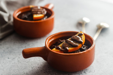 Delicious chocolate pudding with orange. Potted pudding on the table