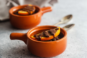 Delicious chocolate pudding with orange. Potted pudding on the table