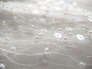 close up on shiny bridal white round sequin fabric texture detail 