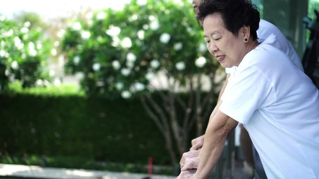 Asian elderly couple quarantine together in condominium with green and nature
