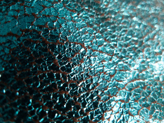 foiled aqua blue fabric background with shinny reflective cracked surface