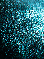 foiled aqua blue fabric background with shinny reflective cracked surface