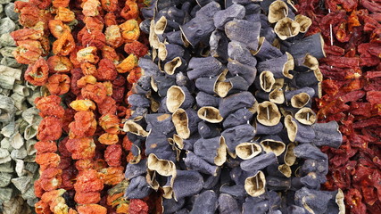 Hanged delicious colorful and sun dried marinated Turkish tomatoes, peppers and eggplants or...