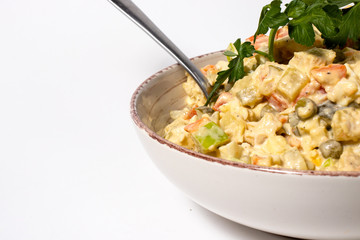 Olivier salad - a classic recipe with mayonnaise, an incredible taste. Olivier salad on a white background, homemade recipe.