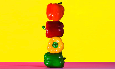 Paprika tower on Yellow background Peppers. Food concept.