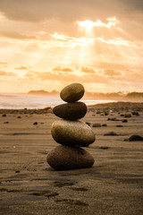 Zen stones on beach, pile of stones by the sea. Balance stones are arranged in a pyramid shape