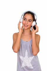 Studio shot of young happy teenage girl listening to music isolated against white background