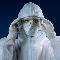 Female Doctor or Nurse Wearing Scrubs and Protective Mask and Goggles Banner.