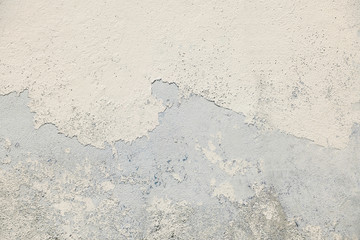 Aged concrete stone wall with rough surface and peeling paint 