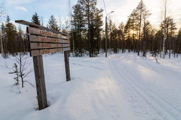 A big sign shows the path destination in a snowy landscape
