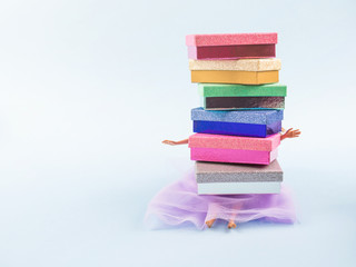 Doll in fashion dress with stack of gift boxes. Shopping, sale concept, birthday party