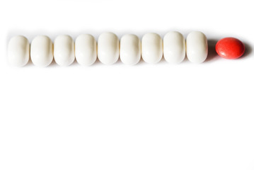 Pills and tablets on bright white background, healthcare medical concept, antibiotics and cure, top view copy space.One bright tablet,Leader concept, thinking out the box