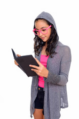 Studio shot of young beautiful teenage girl reading book isolated against white background