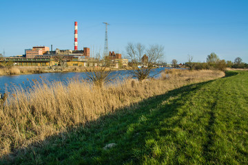 Fototapeta na wymiar Beautiful spring landscape, river, reeds and power plant. Elblag in Poland