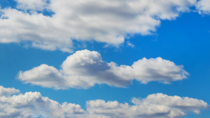 White fluffy clouds in light blue sky