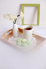 romantic morning greeting card.a Cup of morning tea with macaroons and a flower