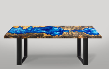 Table modern style made of casting epoxy blue resin maple burl wood  legs made of steel on floor...