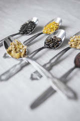 silver spoons with herbal and black tea