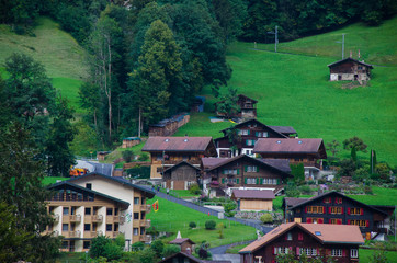 Fototapeta na wymiar View of the mountain village grindelwald. The Storm is Coming In Switzerland. Grindelwald, Switzerland aerial village view and summerSwiss Alps mountains panorama landscape