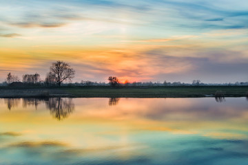 Naklejka na ściany i meble beautiful river landscape, colorful sky after sunset. Nogat River in Poland