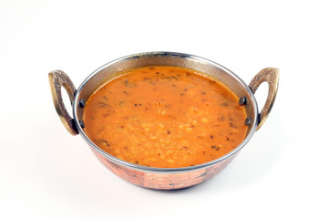 indian style dal lentil tarka spicy ghee fried dish in brass karai bowl pan on white background - obrazy, fototapety, plakaty