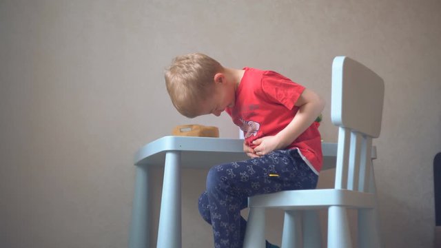 abdominal pain in a child. a little boy with a bout of poisoning while playing at home