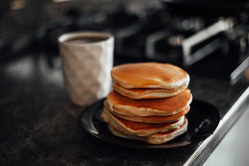 cottage cheese pancake with tea on a wooden stand